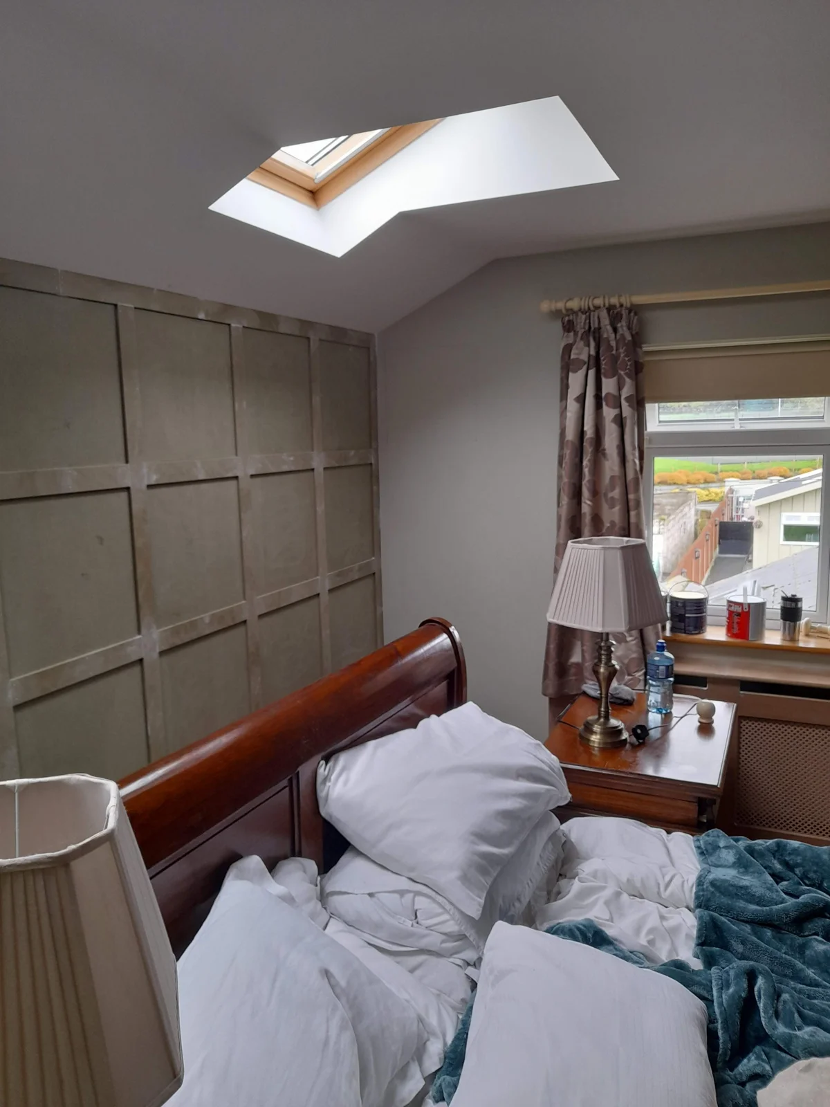 Bedroom with full-height panelled wall